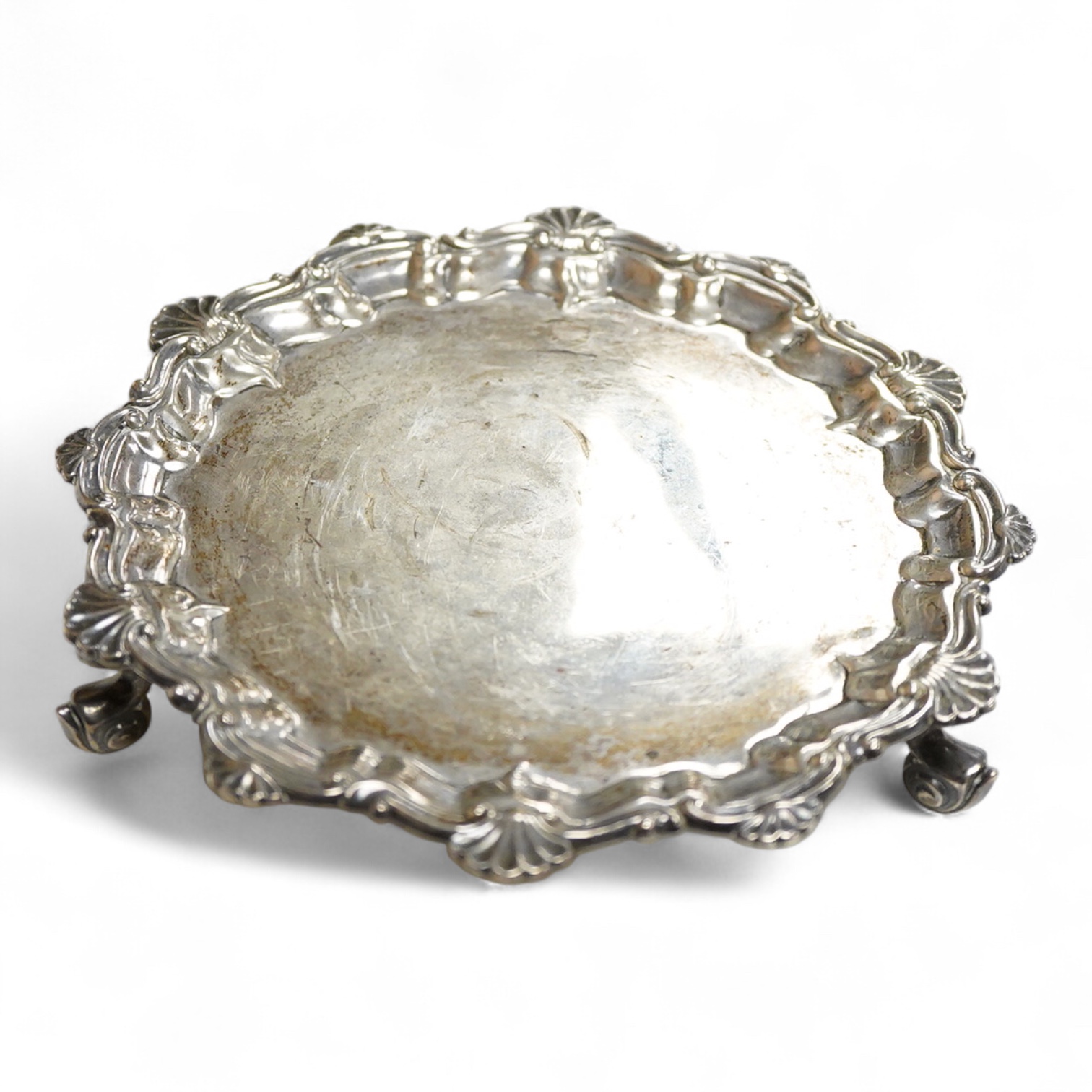 A George V silver waiter, by Barker Brothers, Chester, 1911, with shell and scroll border, on three scroll feet, 15.7cm, 4.5oz.